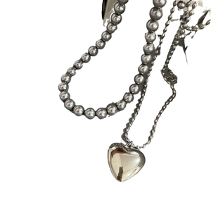 Double-layered gray pearl necklace with a polished hollow heart pendant in titanium steel