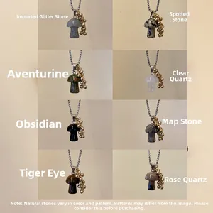 Detail view of various mushroom shaped natural stone pendants with gold bead accents