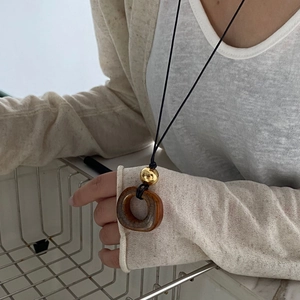 Collana lunga minimalista con pendente ad anello in resina marrone e perla dorata su corda