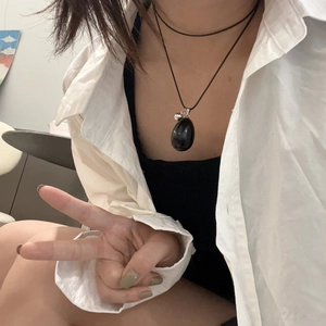 Minimalist black teardrop stone pendant necklace with double-layer cord on model