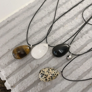 Natural stone egg-shaped drop pendant necklaces in tiger eye and obsidian on stone