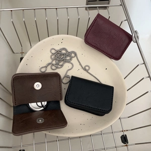 Mini leather chain bags in dark brown, black, and burgundy with metal straps