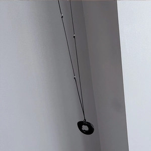 Détail du collier pendentif cercle noir minimaliste avec perles argentées sur cordon