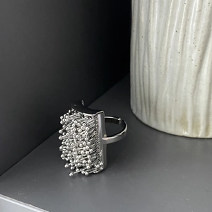 Macro shot of silver fireworks seed style cluster ring with adjustable open band detail