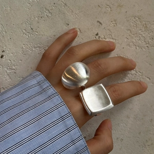 Exaggerated brushed silver open ring with unique geometric egg and square design