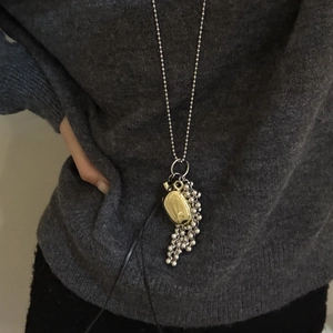 Mixed metal long ball chain necklace with gold oval pendant and silver grape tassel charm