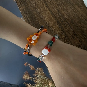 Detail of Christmas gingerbread man and Santa beaded bracelets with colorful stones