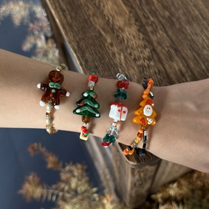 Detailed view of colorful Christmas glass bead bracelets with festive holiday charms