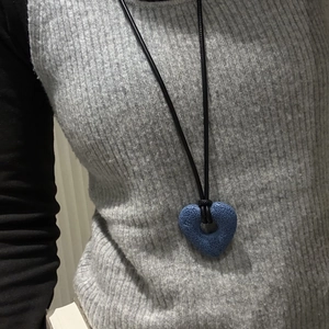 Minimalist long sweater necklace featuring a blue volcanic stone hollow heart pendant
