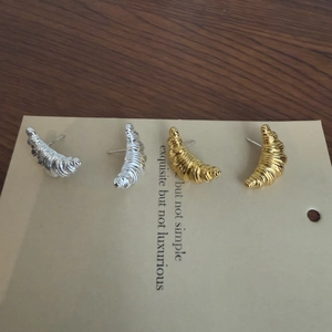 Minimalist croissant stud earrings in gold and silver finish with spiral texture
