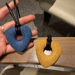 Minimalist heart-shaped lava stone pendant necklace on black leather cord
