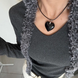 Minimalist titanium steel necklace featuring a polished black heart pendant on a cord