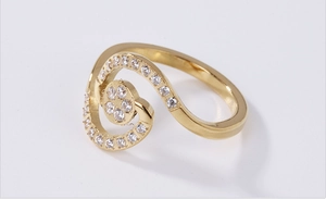 Macro shot of rose gold spiral ring with elegant white cubic zirconia stone setting