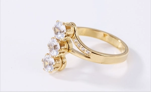 Detail of three-stone gold ring featuring vertical main gems and diamond-encrusted band
