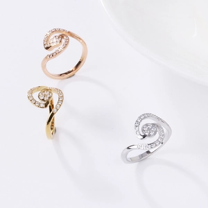 Three-piece set of spiral rose gold, gold and silver rings with pave crystal stones