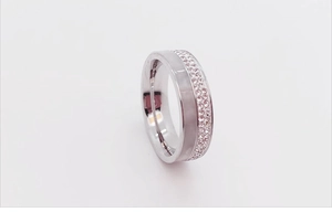 Detailed close-up of rose gold ring featuring double-row crystal pave and shell inlay