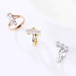 Three-color crisscross rings in rose gold, gold, and silver with triple-stone settings