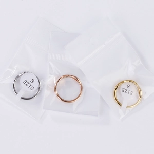 Crisscross sparkling rhinestone rings in silver, gold, and rose gold with size 8 labels