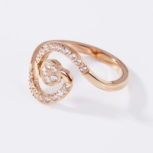 Elegant rose gold spiral ring for women featuring micro-pave crystals and a central disc
