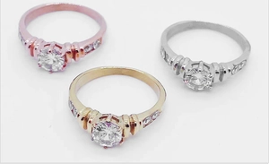 Detailed view of women's ring set in rose gold, gold and silver finishes with round cz stones