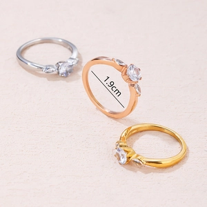 Three minimalist titanium steel rings in gold, rose gold and silver with zircon accents