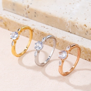 Three-piece ring set in gold, silver, and rose gold with round and marquise-cut zircons