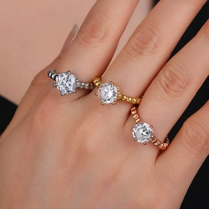 Six-prong rose gold solitaire ring with beaded twisted band and sparkling zircon stone