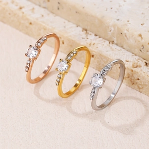 Three elegant thin rings in rose gold, gold, and silver with central round cz and side stones