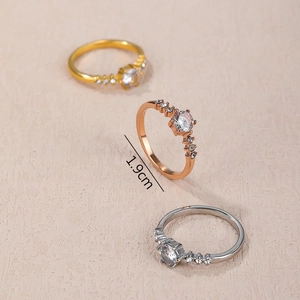 Three zirconia rings in gold, rose gold and silver finish with 1.9cm inner diameter