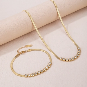 Flat herringbone snake chain set with round zircon stones in a gold finish