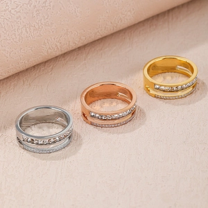 Close-up of double-layered titanium steel rings with cubic zirconia in gold and silver