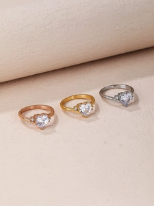 Detailed view of heart-shaped gemstone rings set in rose gold, yellow gold, and silver