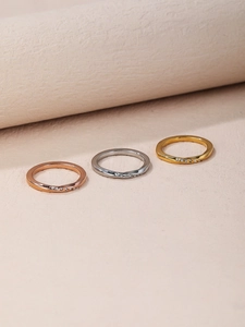 Detail view of trio Mobius rings in rose gold, silver, and gold with cubic zirconia