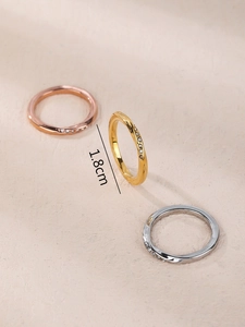 Detail view of twisted Mobius rings in gold and silver showing 1.8cm diameter