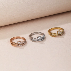 Three-color crisscross rings in gold, silver and rose gold with pavé-set zircons