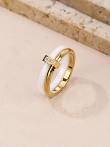 Detailed macro view of dual band ring featuring white ceramic and gold zircon inlay