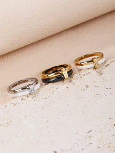 Three-color ceramic and stainless steel rings with zircon settings on stone base