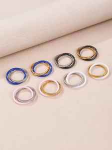Detailed view of double-layered interlocking rings with inlaid zircon stones on metal bands