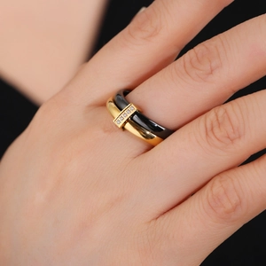 Chic black ceramic and gold stainless steel ring featuring five inset zircon stones
