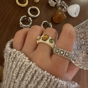 Detailansicht eines Harzrings mit Bernstein und eines silbernen Spitzenrings