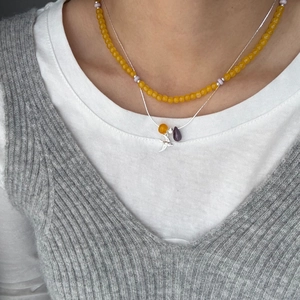 Double-layered necklace with yellow agate beads, purple crystal, and swallow pendant