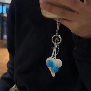 Handmade beaded phone charm with blue beads, white heart pendant and metal clasp