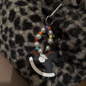Bowknot rocking horse bag charm with colorful beads and white pearls on leopard print bag