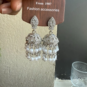 Detail of silver vintage Jhumka earrings with tassels of white pearls and rhinestones