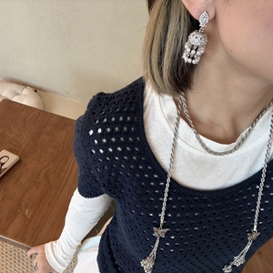 Detail view of vintage silver tassel earrings with pearls and butterfly pendant necklace