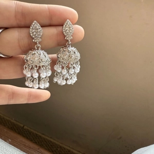 Classic silver Jhumka earrings with sparkling rhinestones and long white pearl tassels