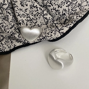 Minimalist matte silver heart ring with brushed metal texture and open adjustable band