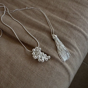 Silver bead cluster pendant necklace with tassel and mixed chain link design