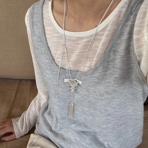 Detail of silver grape cluster pendant with metallic tassels and adjustable chain length