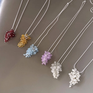 Detailed view of colorful crystal grape cluster pendants on slim silver chains